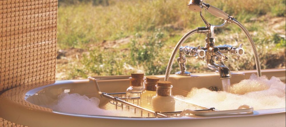 A private soaking tub for ultimate relaxation at Kwandwe River Lodge, Kwandwe Private Game Reserve, South Africa - Image 4