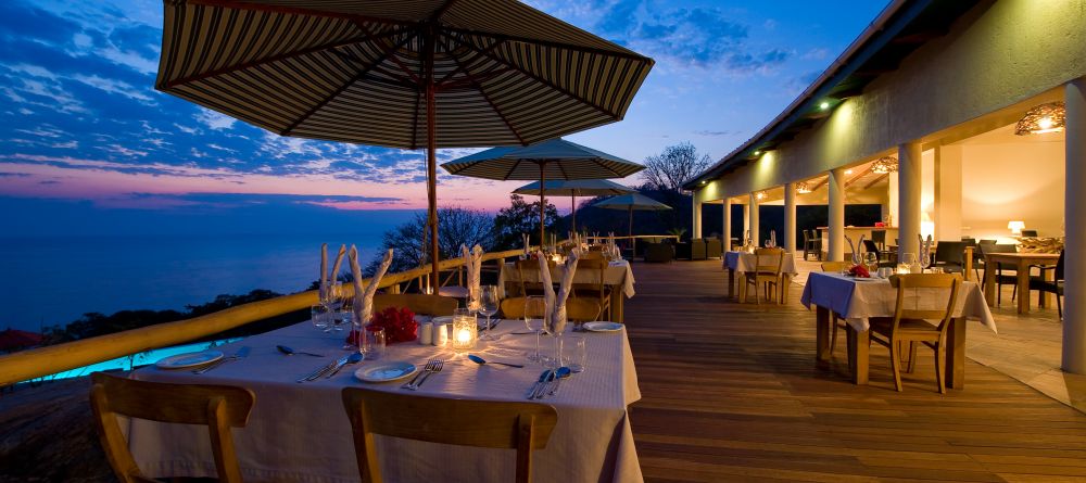 Outdoor dining in the evening at Pumulani, Lake Malawi, Malawi - Image 13