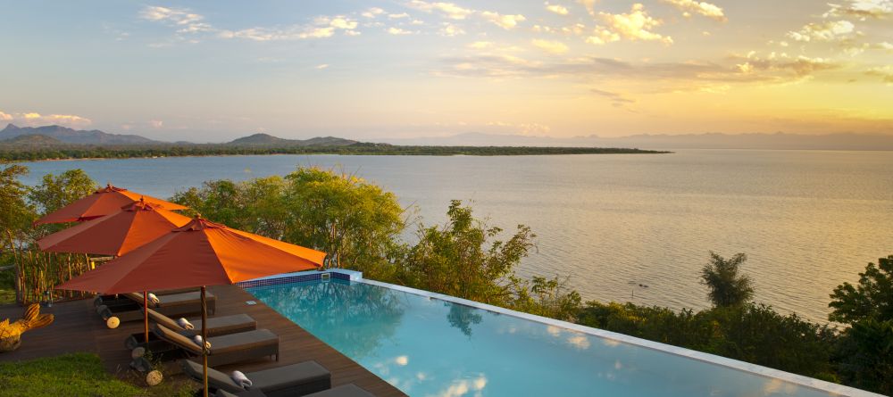 The sun sets over the pool at Pumulani, Lake Malawi, Malawi - Image 15