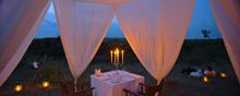 Elegant outdoor evening dining at Naibor Camp, Masai Mara National Reserve, Kenya