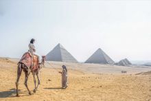 Camel ride with pyramids