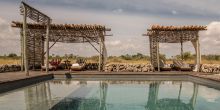 Soak up sun by the pool overlooking the nearby wildlife at Chem Chem Lodge, Lake Manyara National Park, Tanzania