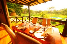 The dining area overlooks the pool and lush surroundings at The Emakoko, Nairobi National Park, Nairobi, Kenya