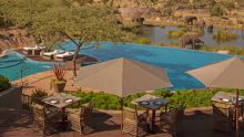 Float on the magnificent infinity pool while watching a herd of elephants gather at the watering hole at The Four Seasons Safari Lodge, Serengeti National Park, Tanzania