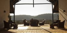 Sit on the veranda overlooking the valley at Kitela Lodge and African Spa, Karatu, Tanzania