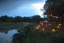 Private dining by the river at Naibor Camp, Masai Mara National Reserve, Kenya