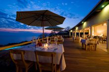 Outdoor dining in the evening at Pumulani, Lake Malawi, Malawi