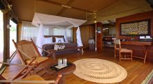 The luxurious bedroom with elements of African and Victorian-inspired decor at Serengeti Bushtops Camp, Serengeti National Park, Tanzania