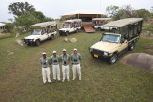 Safari guides await by their vehiclesr at Serengeti Bushtops Camp, Serengeti National Park, Tanzania