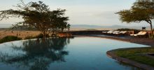 Relax by the pool and enjoy the stunning vistas at Singita Sasakwa Lodge, Grumeti Reserves, Tanzania