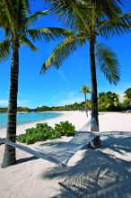 Relax in a hammock on a pristine beach at Le Touessrok Resort, Trou d-eau Douce, Mauritius